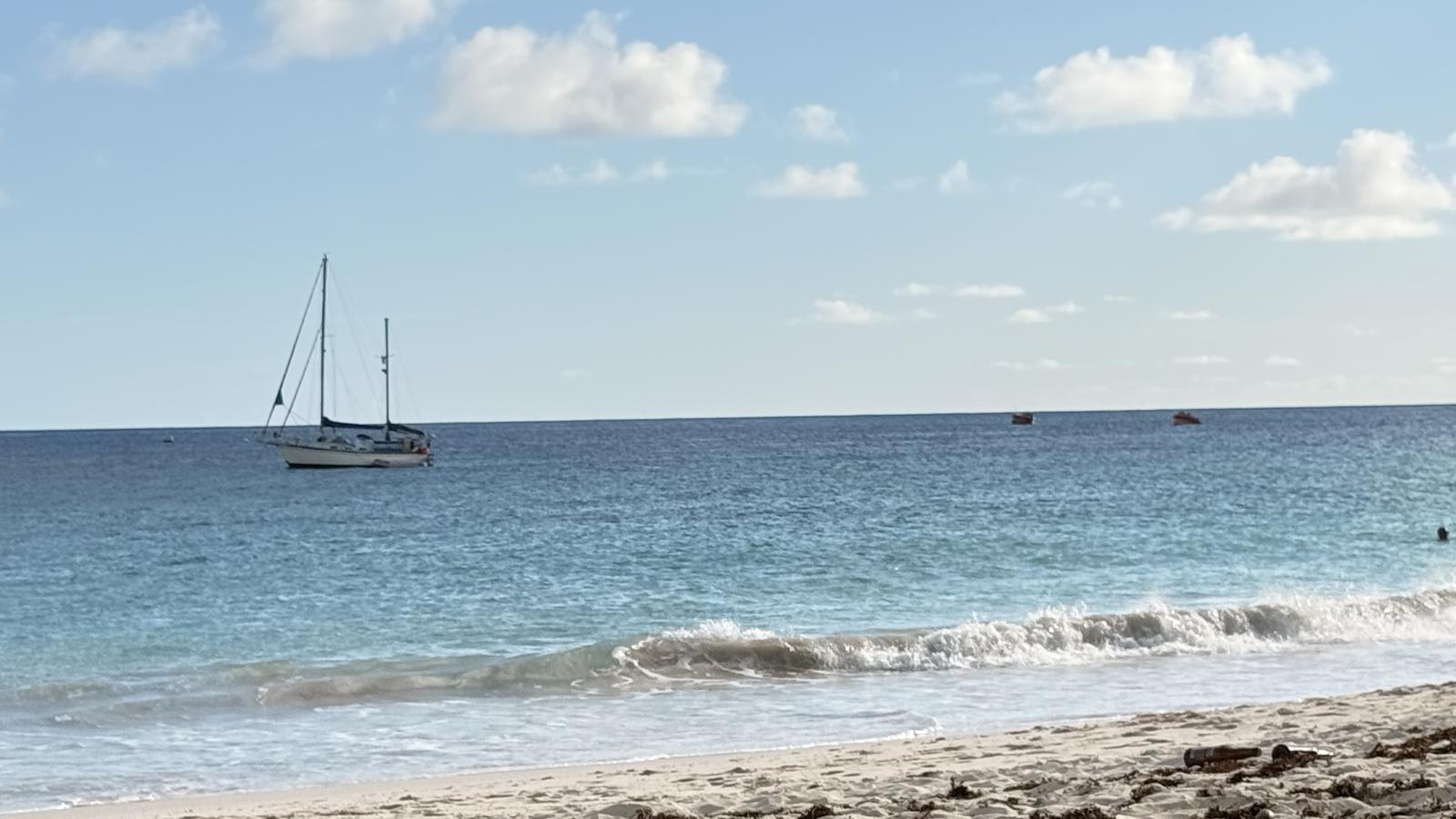 A sailboat anchored off the beach