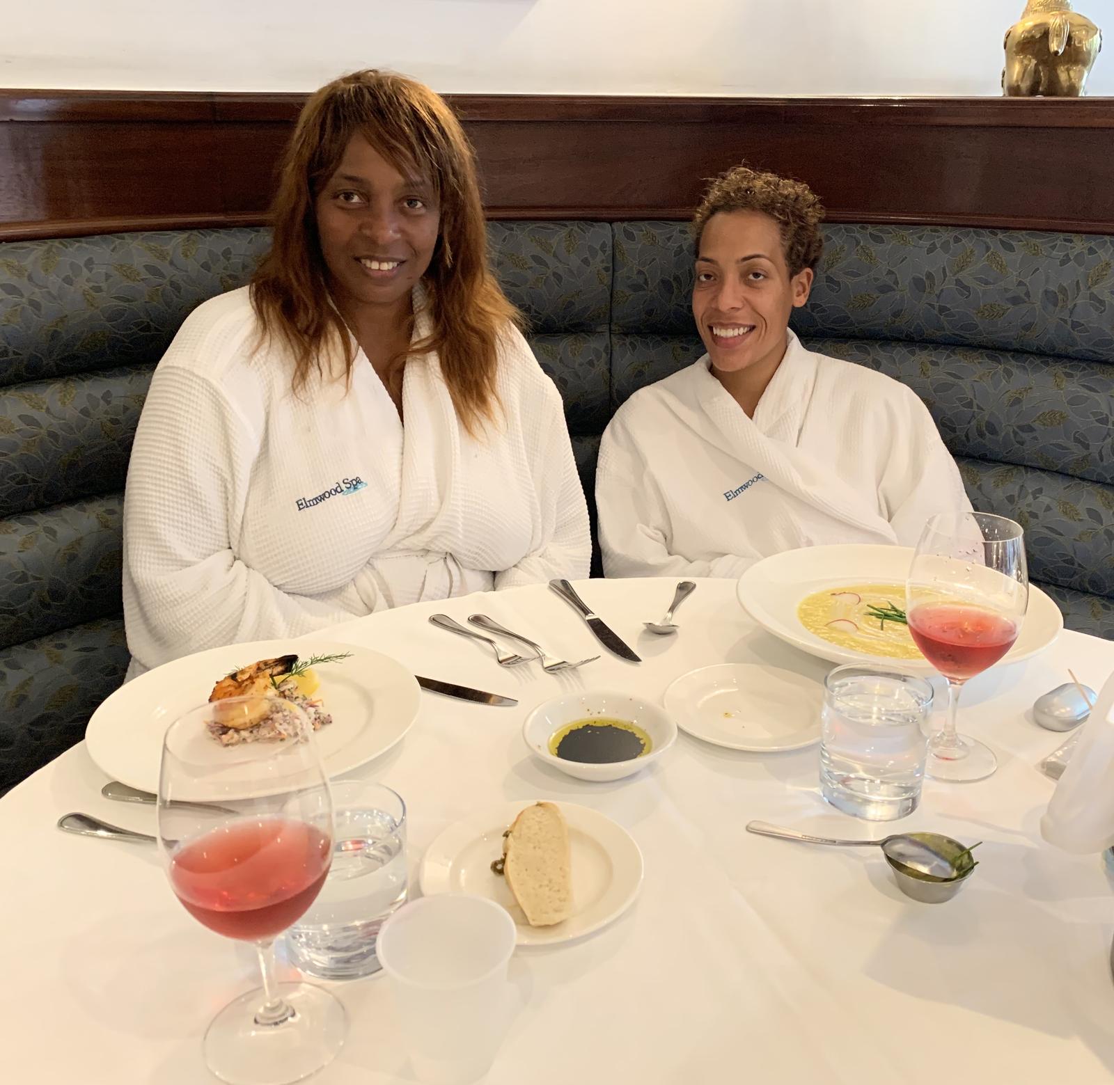 Kathryn and Keshia in spa robes at lunch