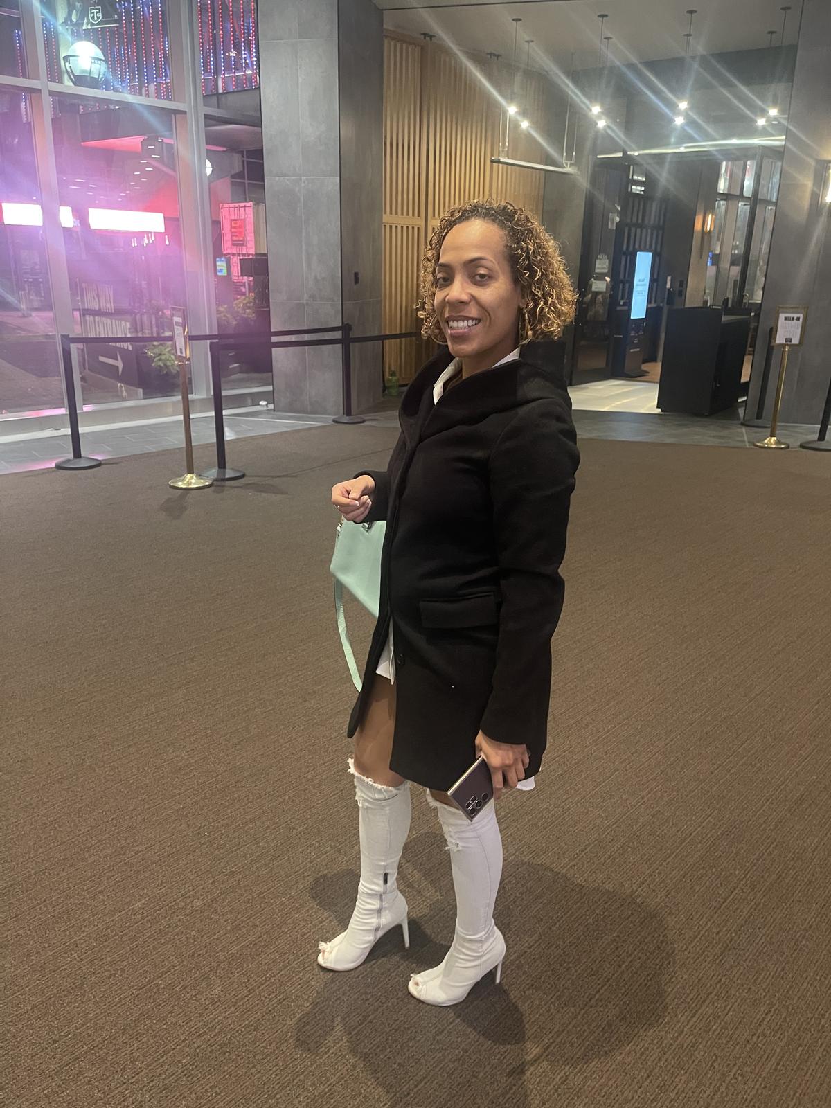 Keshia in a black coat and white boots