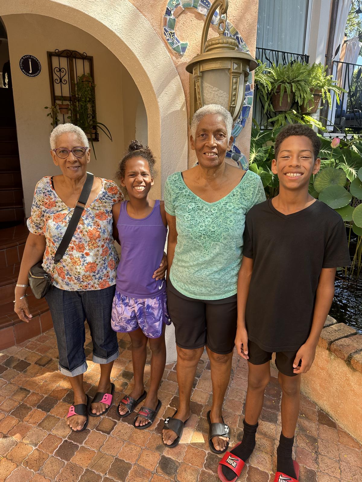 Monica with family outside a Spanish-style doorway