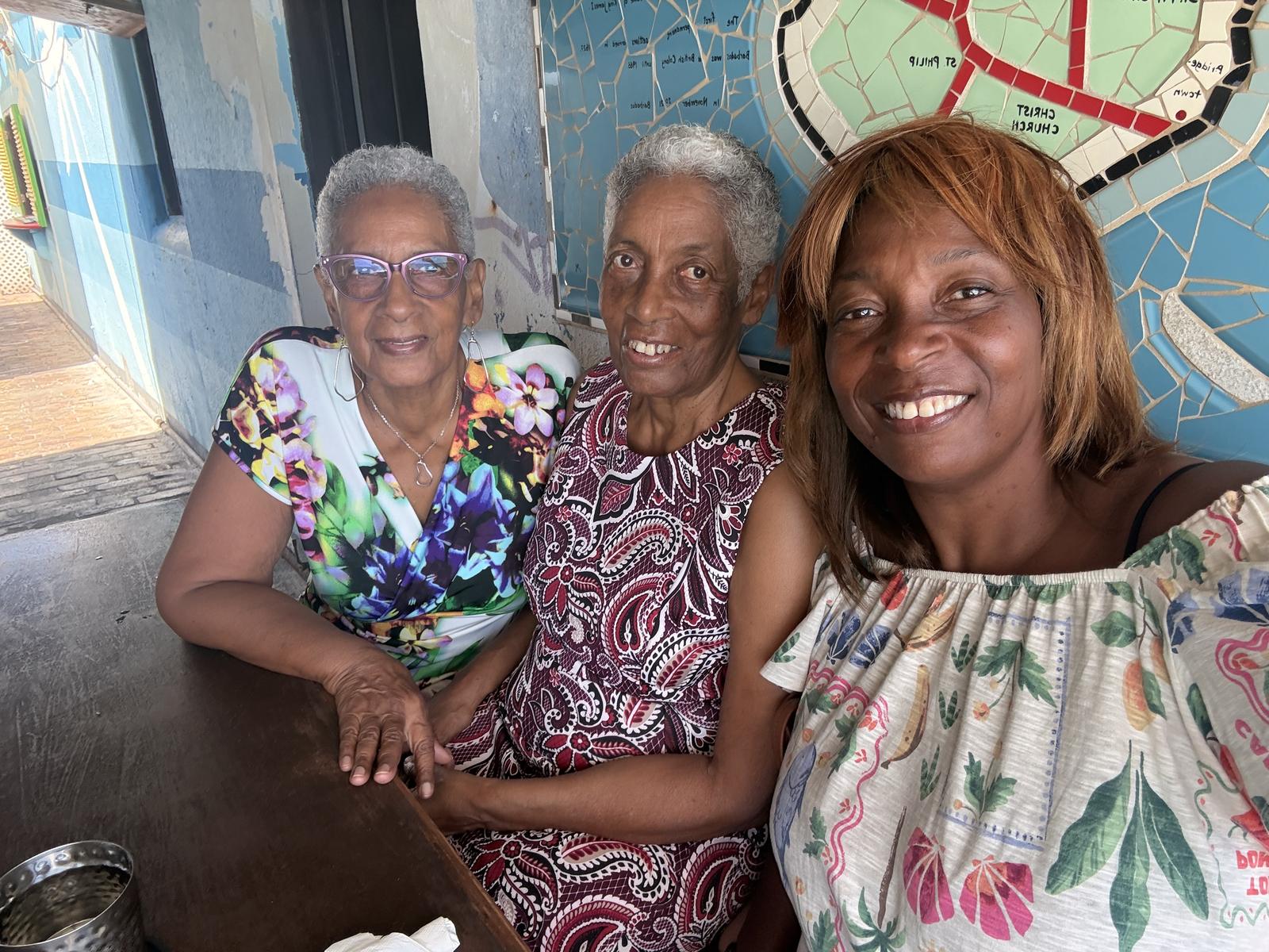 Monica with family at a mosaic wall